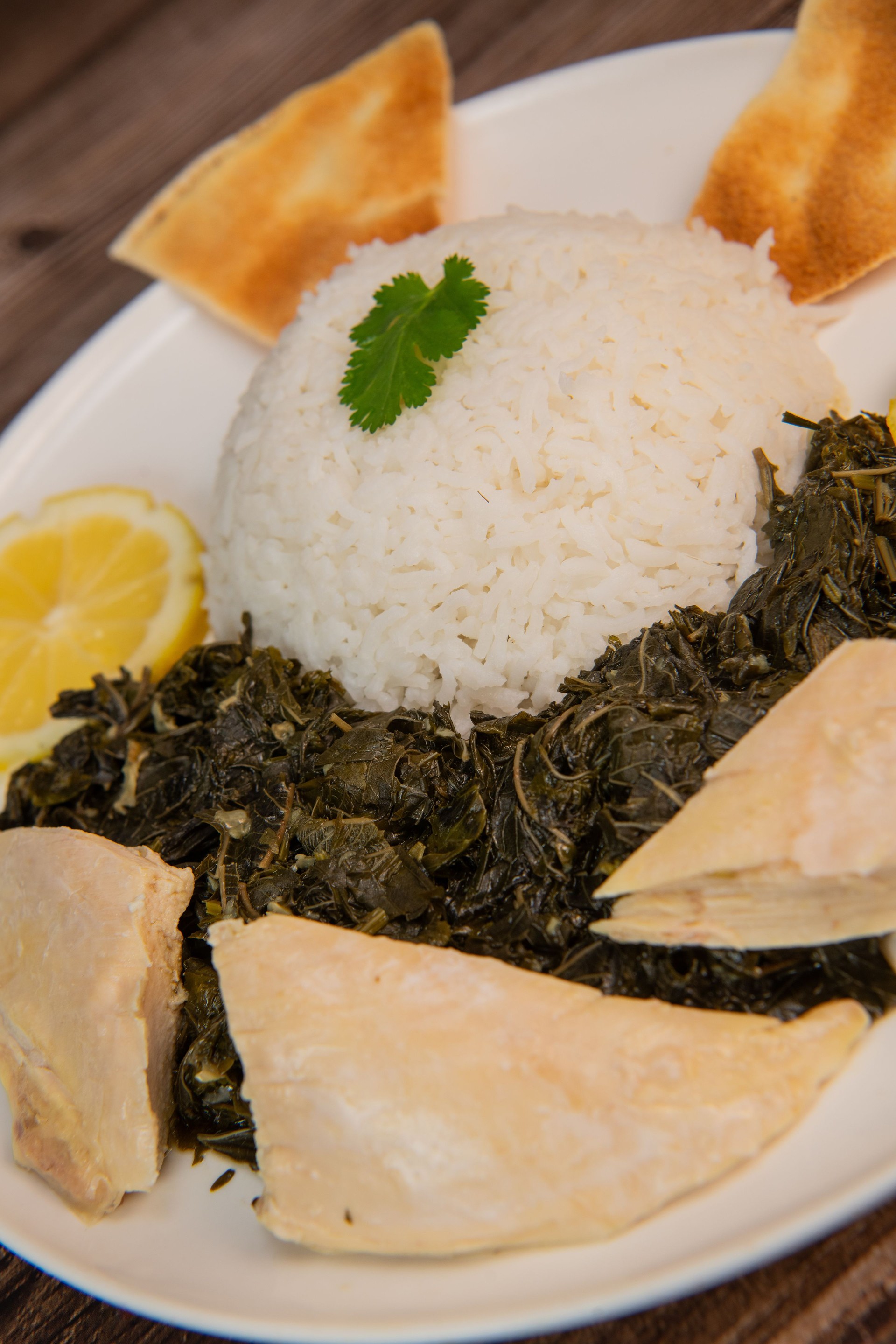 Lebanese recipe Mouloukhia , Melokhiyah, corete leaf and coriander rice chicken, grilled pita