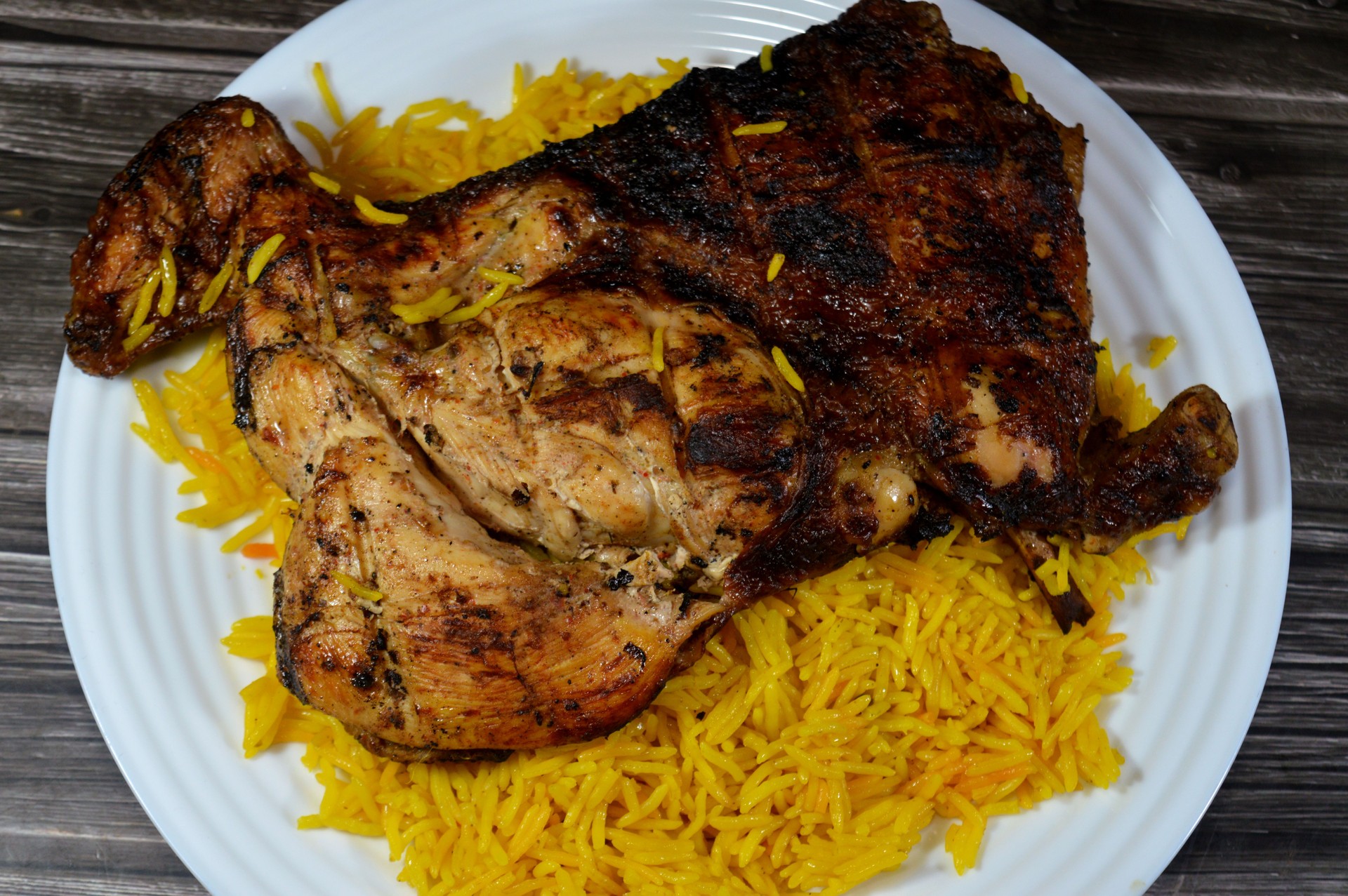 barbecued charcoal grilled  chicken Arabian cuisine, recipe, moist and juicy barbecued bbq chicken half served with Yellow Basmati rice